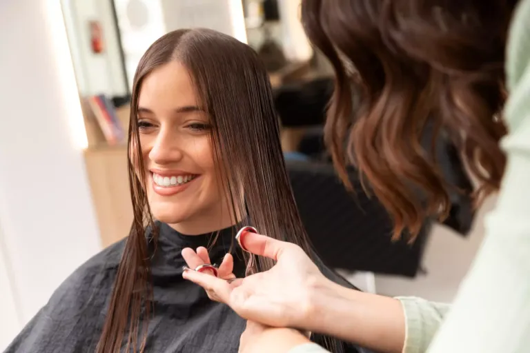 Mujer cortando el pelo a otra mujer